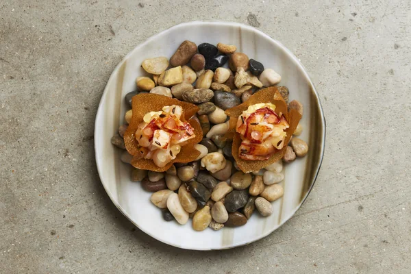 Snacks presented on pebbles at Restaurant Story