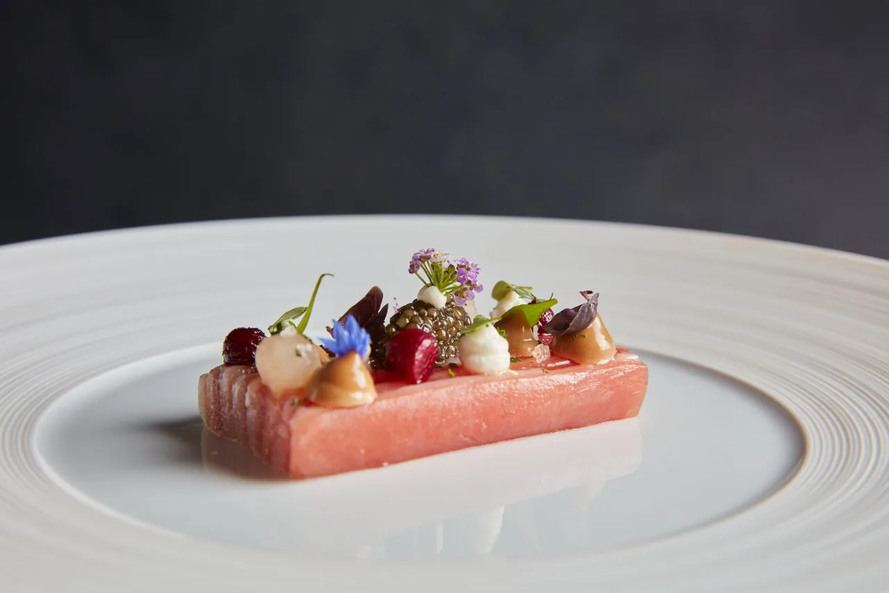 A finely plated dish with flowers and garnishes at Lympstone Manor