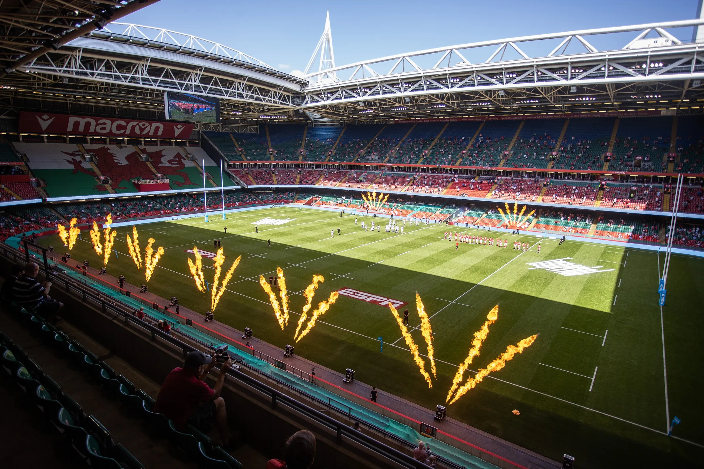 Flames along the touchline before an international at the Principality Stadium in Cardiff, with the crowd filling the stands.