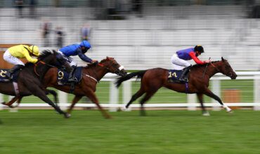 Image of horses racing of the track at Ascot