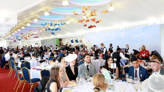 Image of guests at Royal Ascot in the Pavilion sat on large private tables ready for service