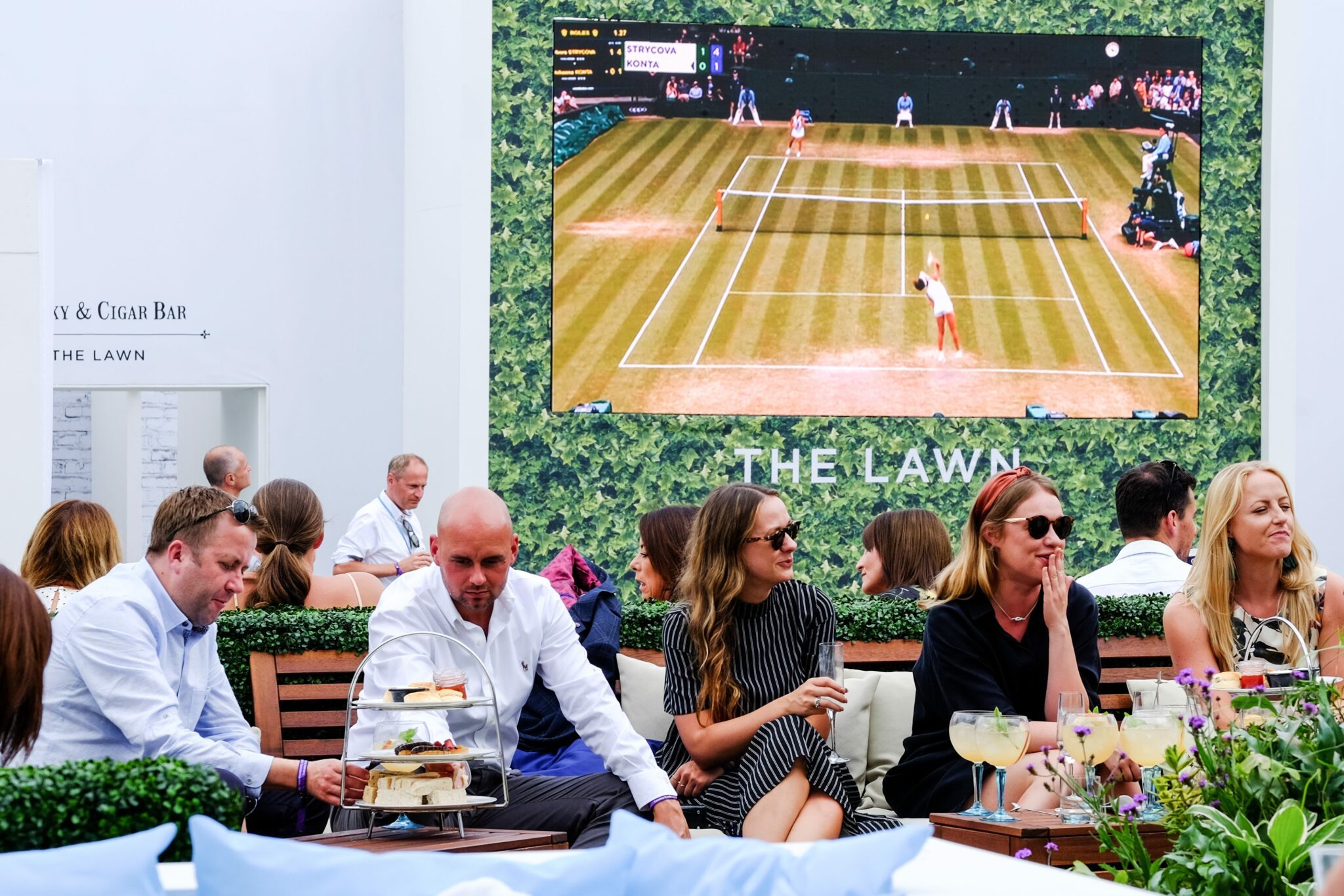 Image of The Lawn and people sat outdoors at Wimbledon