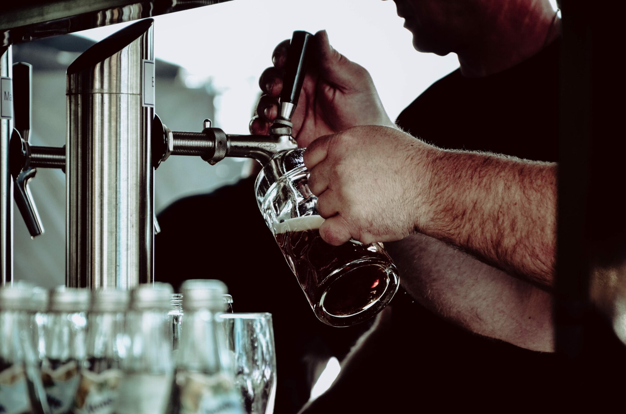 Image of hands pulling a pint into a glass