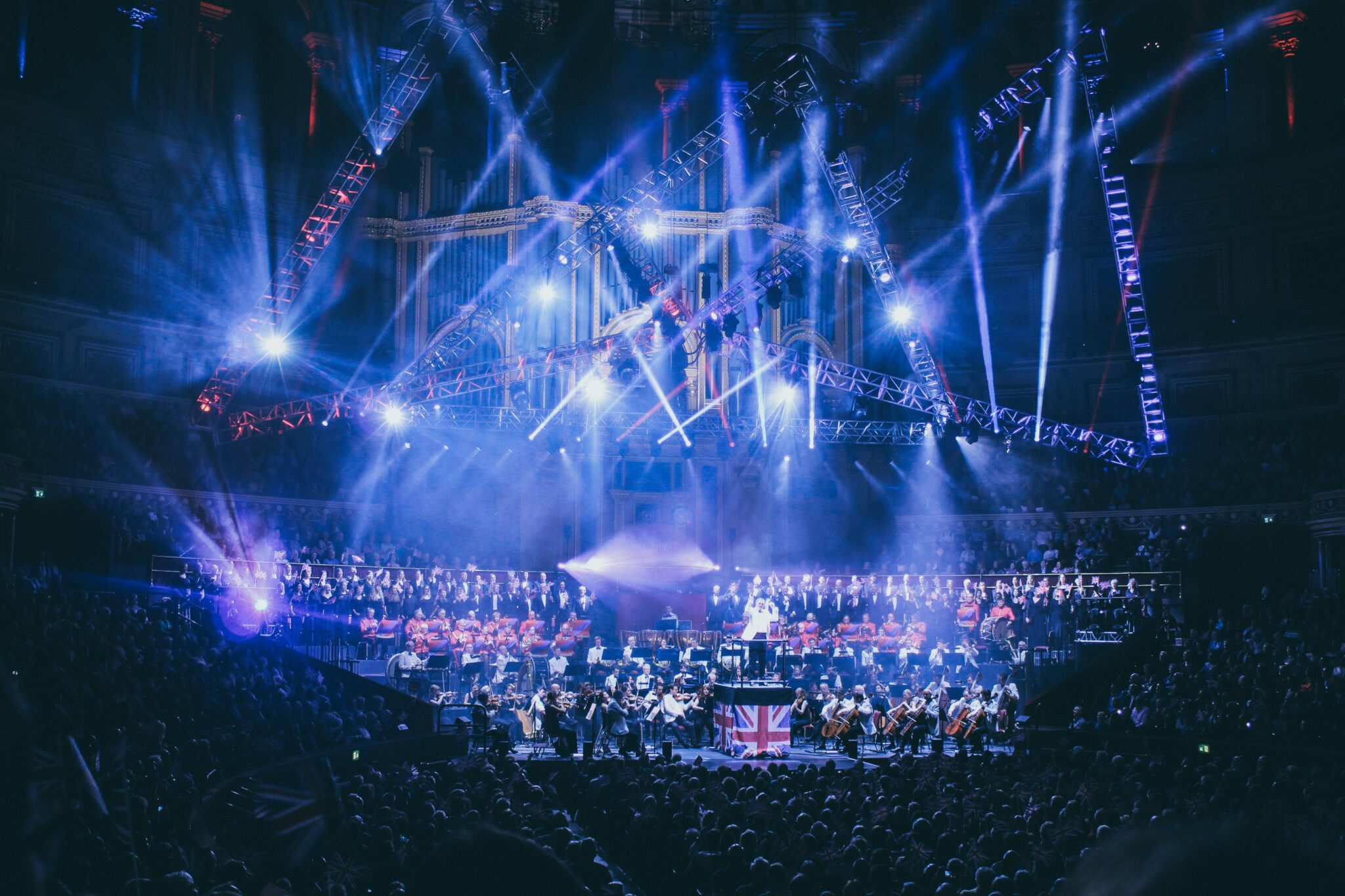 Orchestra playing at the Royal Albert Hall with flashing lights