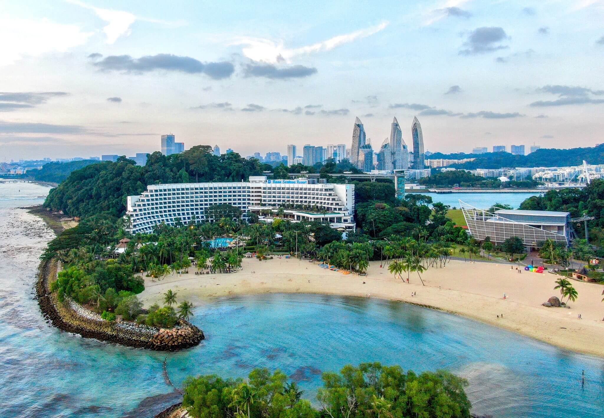 Image of the Shangri-La from above with the private beach and singapore city buidings in the background