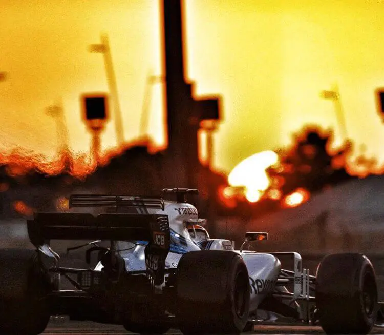 Image of race car on track at sunset