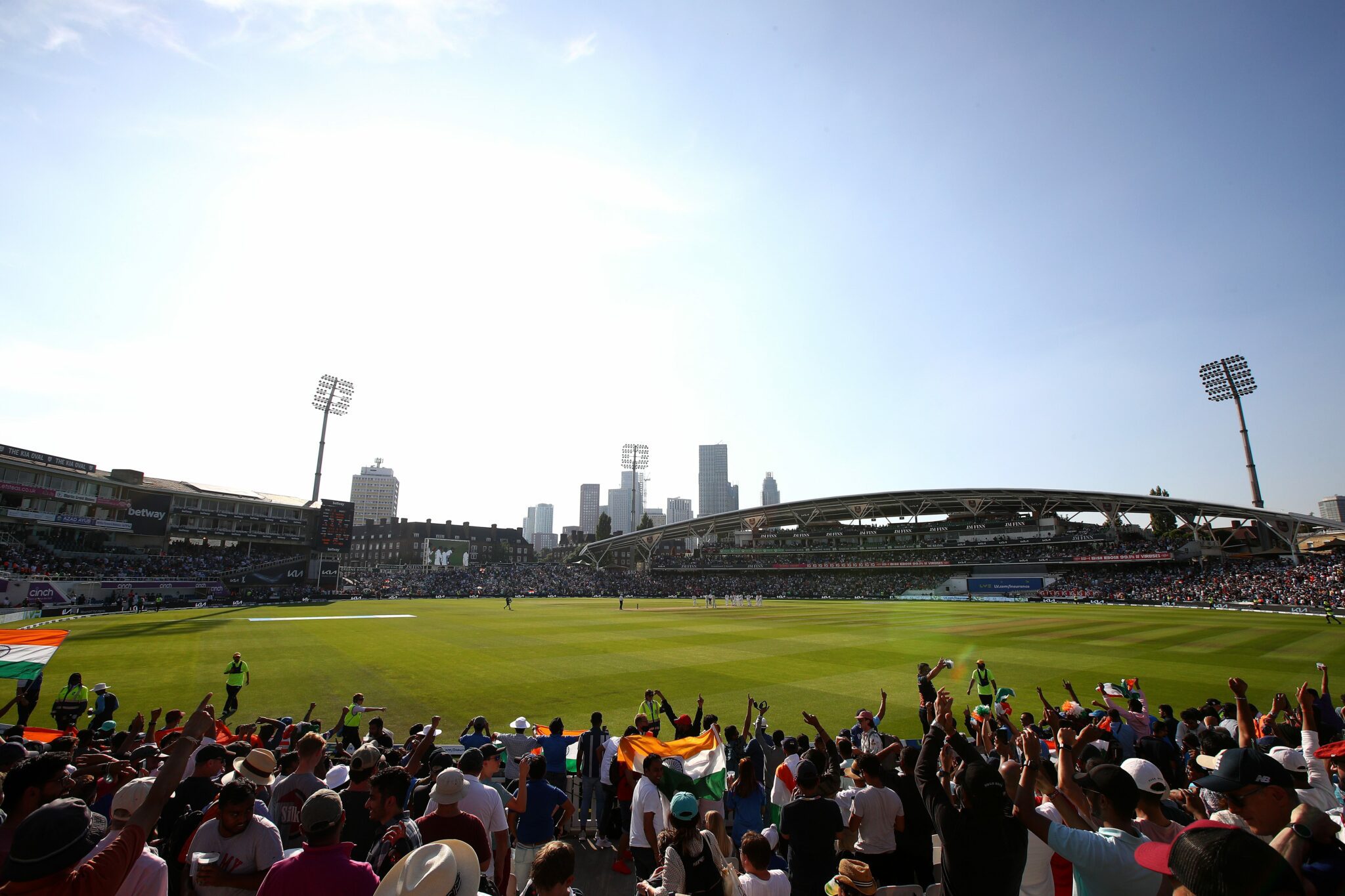 Image of the Kia Oval cricket ground and a crowd cheering, with a skyline in the background