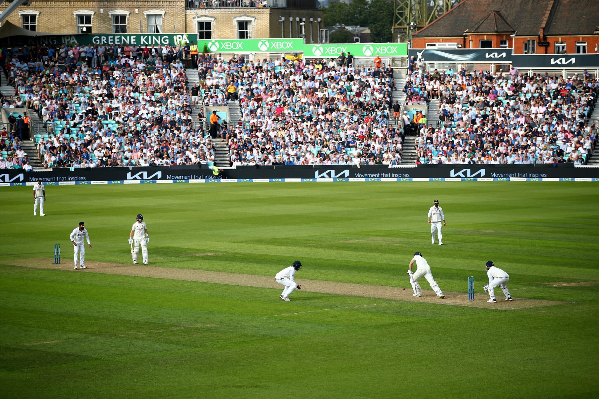 Image of cricket players on the cricket pitch during a game