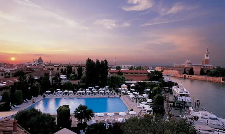 Image of the hotel outdoor pool at sunset