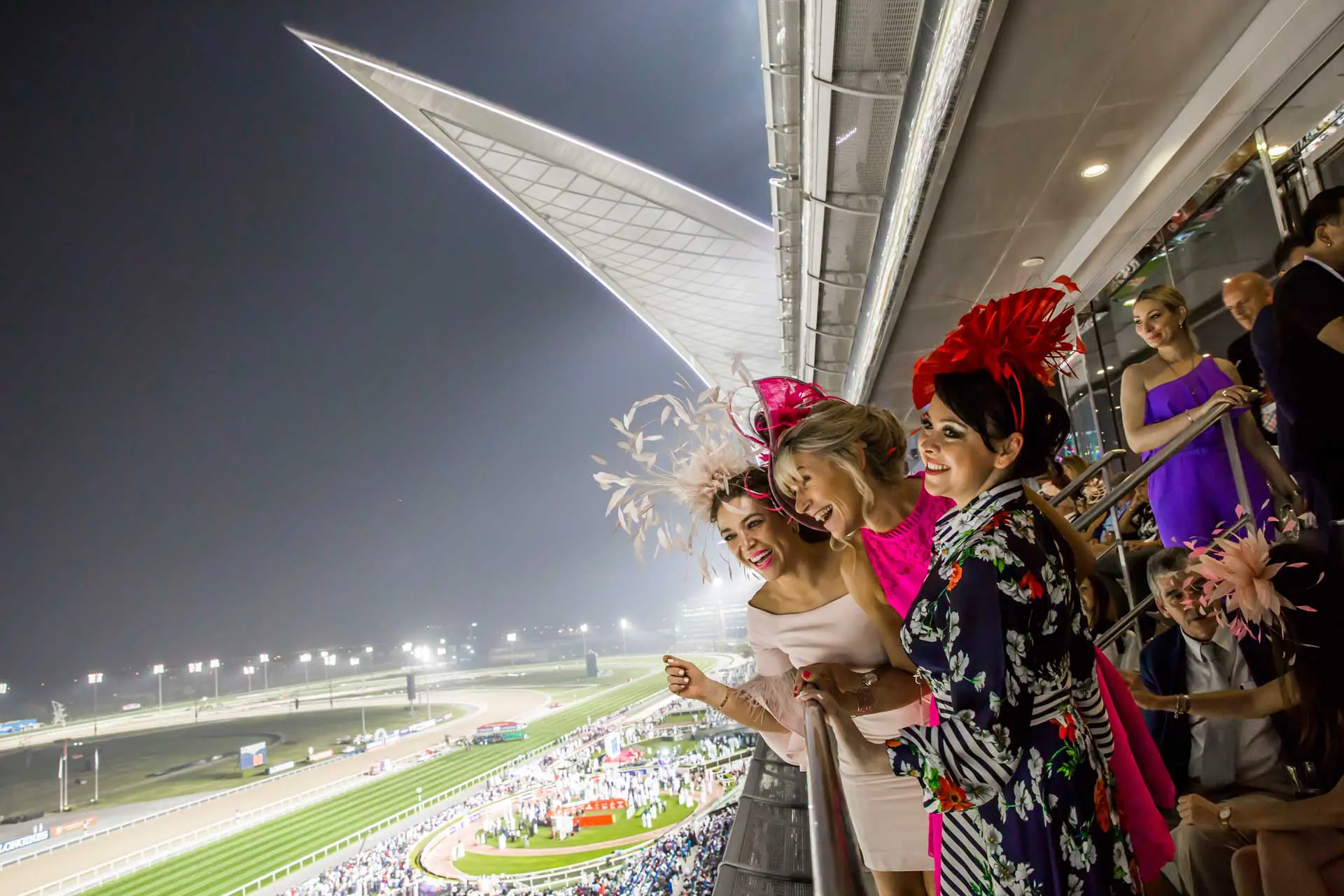 Image of 3 ladies laughing and enjoying the Dubai World Cup from their private seating area