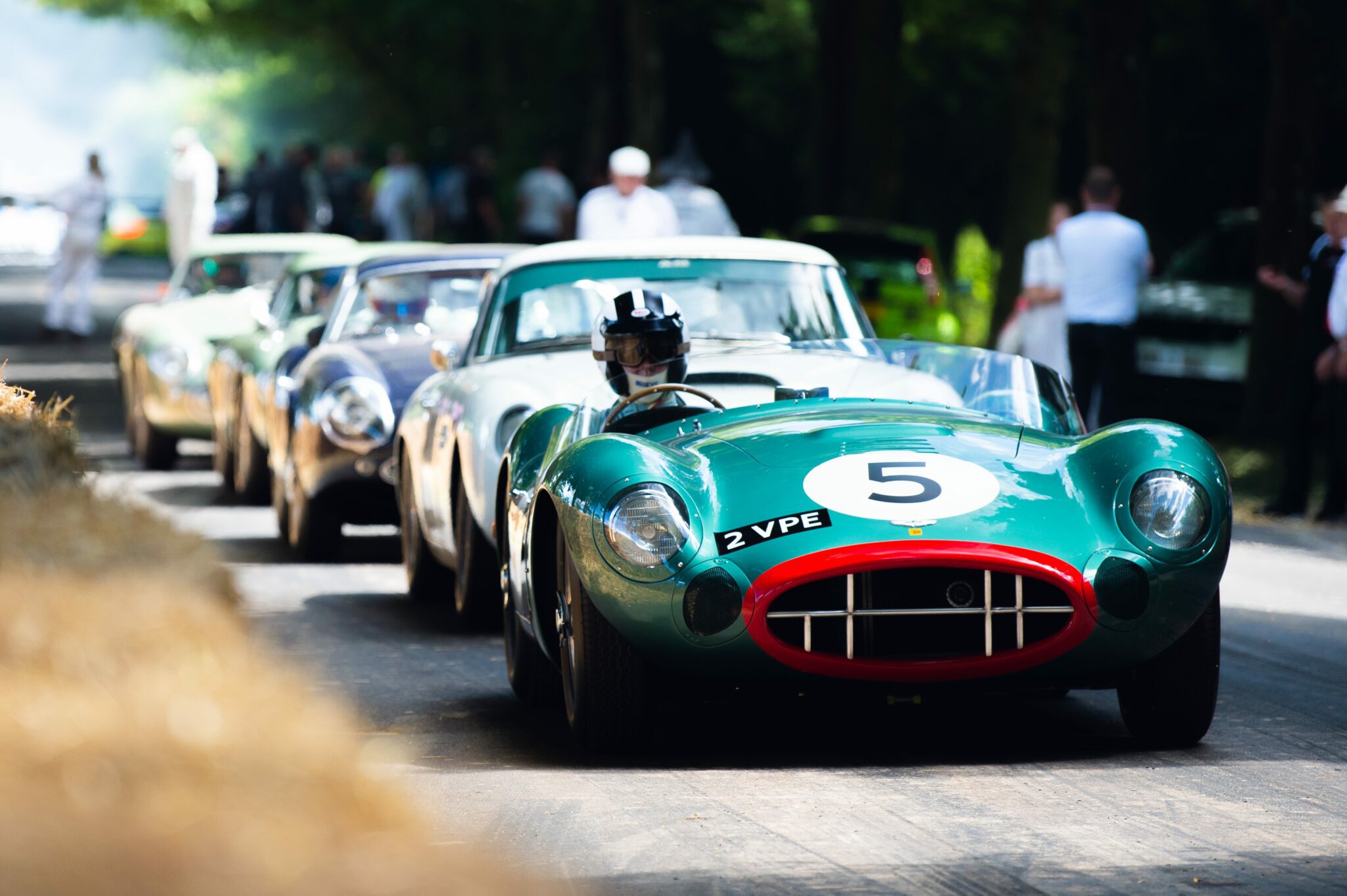 Vintage race cars lined up on the Goodwood racetrack