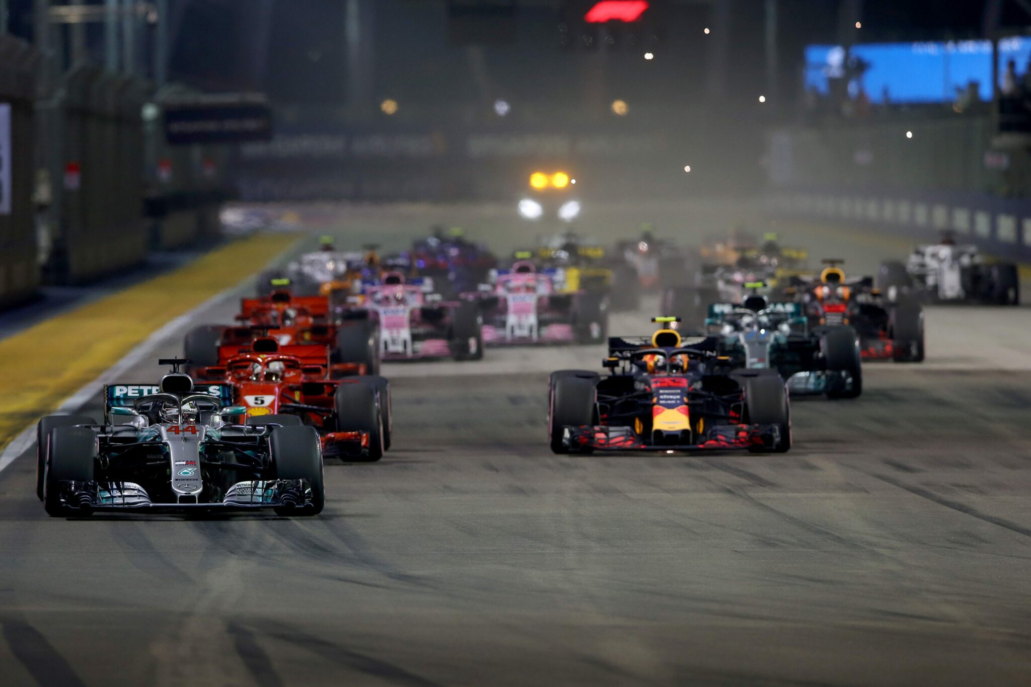 Image of cars racing on the singapore race track at night