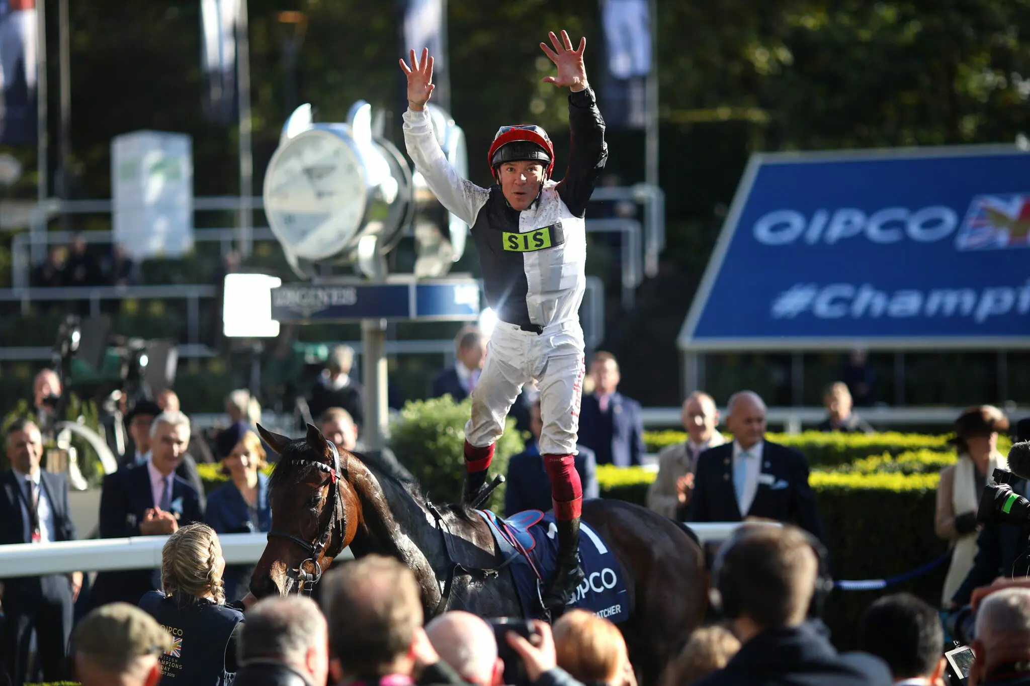 Image of a jockey cheering on top of horse at Ascot