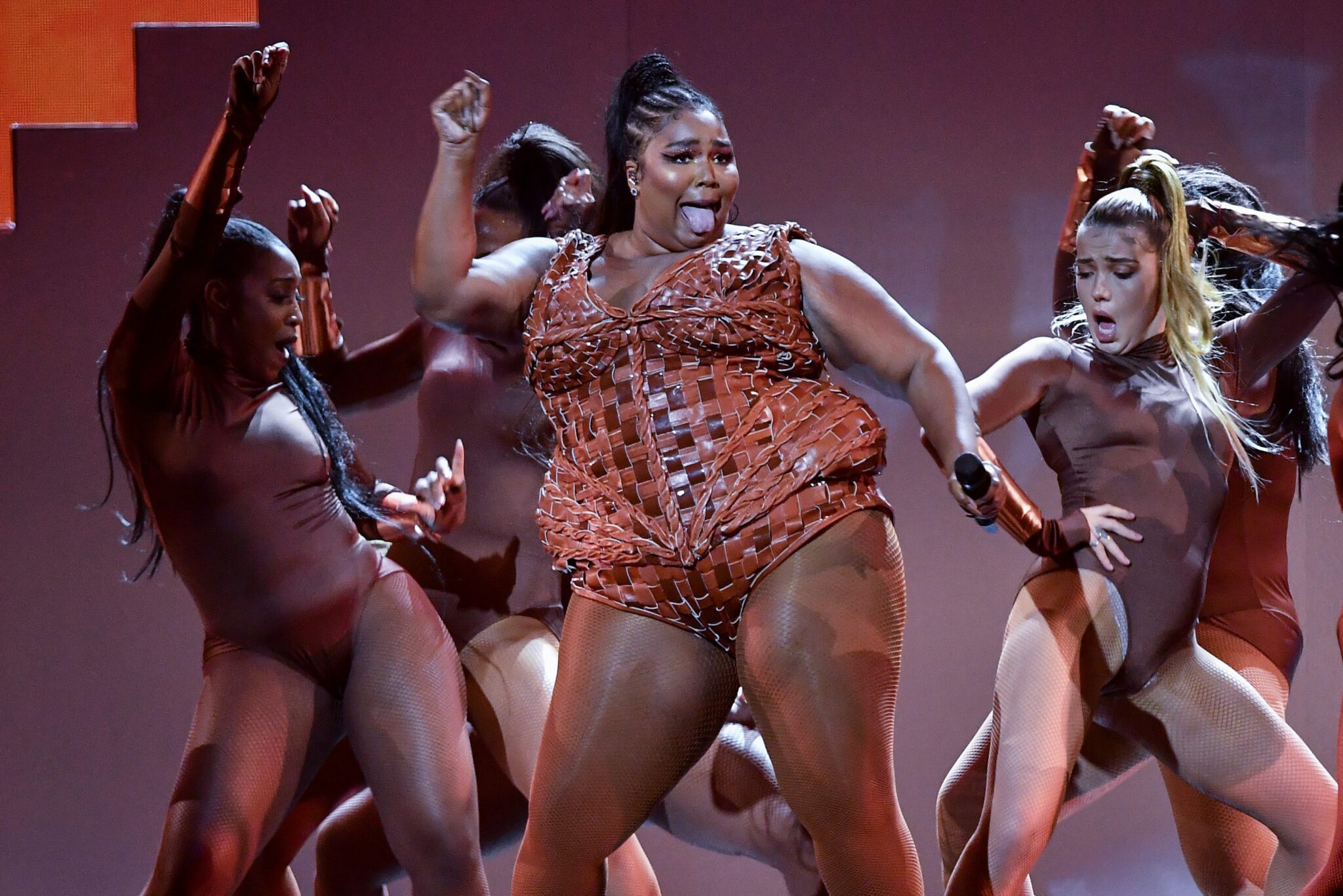 Image of Lizzo performing at the Brits with backing dancers