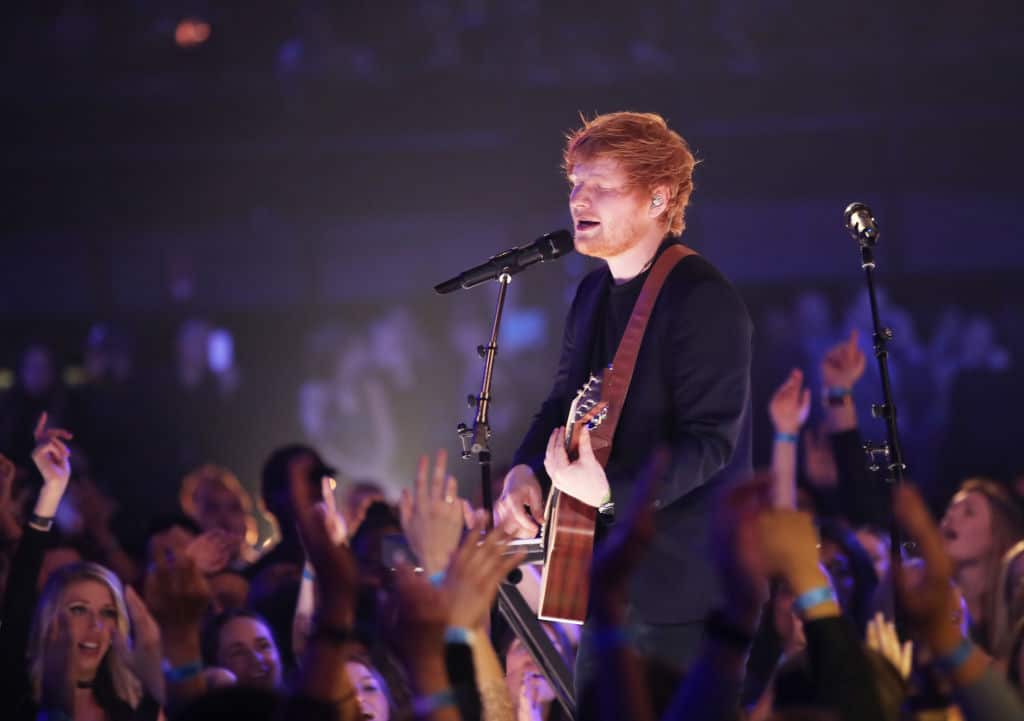 Image of Ed Sheeran performing live on stage with guitar