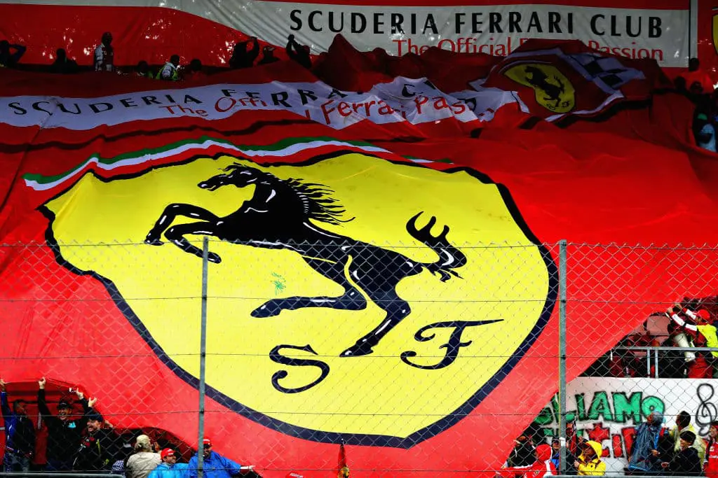 Image of crowds holding the Ferrari symbol printed on a large sheet