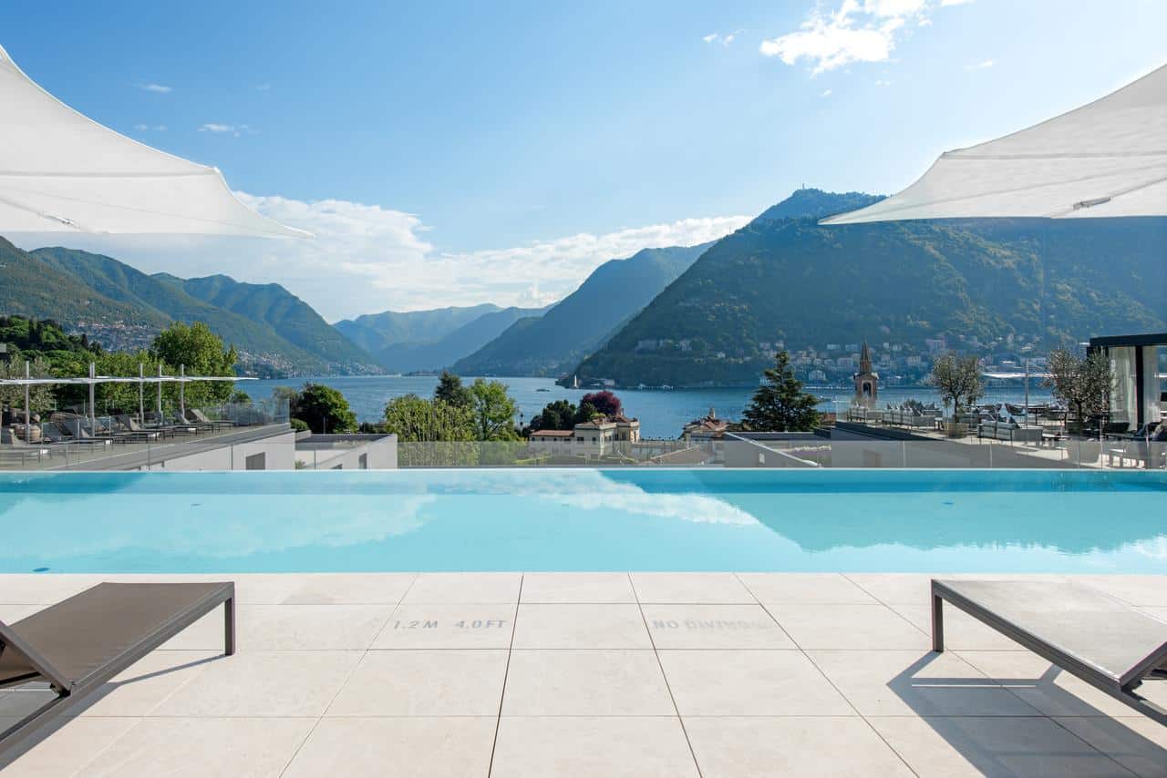 Image of the pool overlooking lake como in Italy with sun loungers