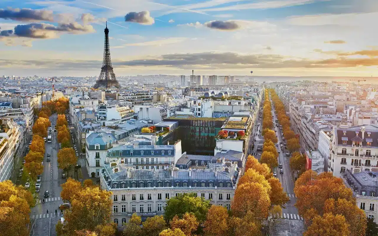An image overlooking Paris from a above including the Eiffel tower and french buildings