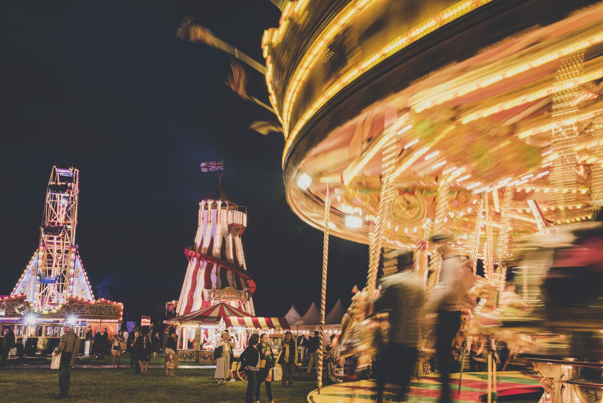 Carousel and other fairground rights at nighttime at Goodwood