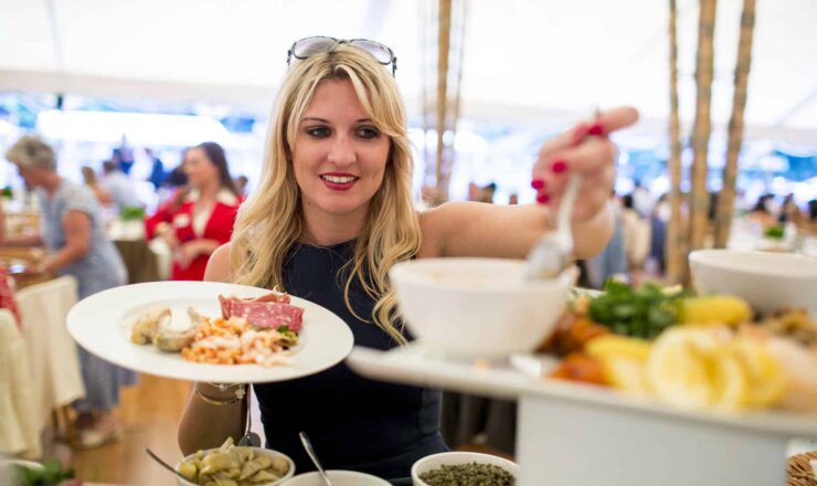 Image of a lady serving herself buffet foot in the marquee