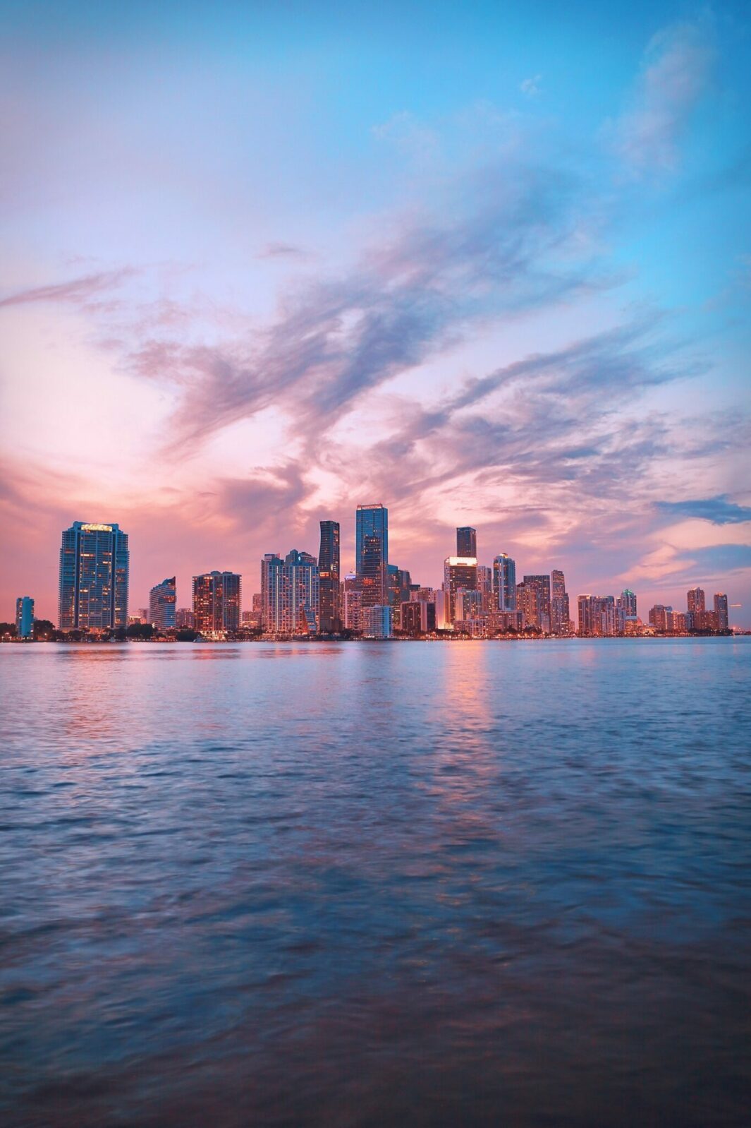 Image of the Miami twighlight skyline with the sea and skyscrapers