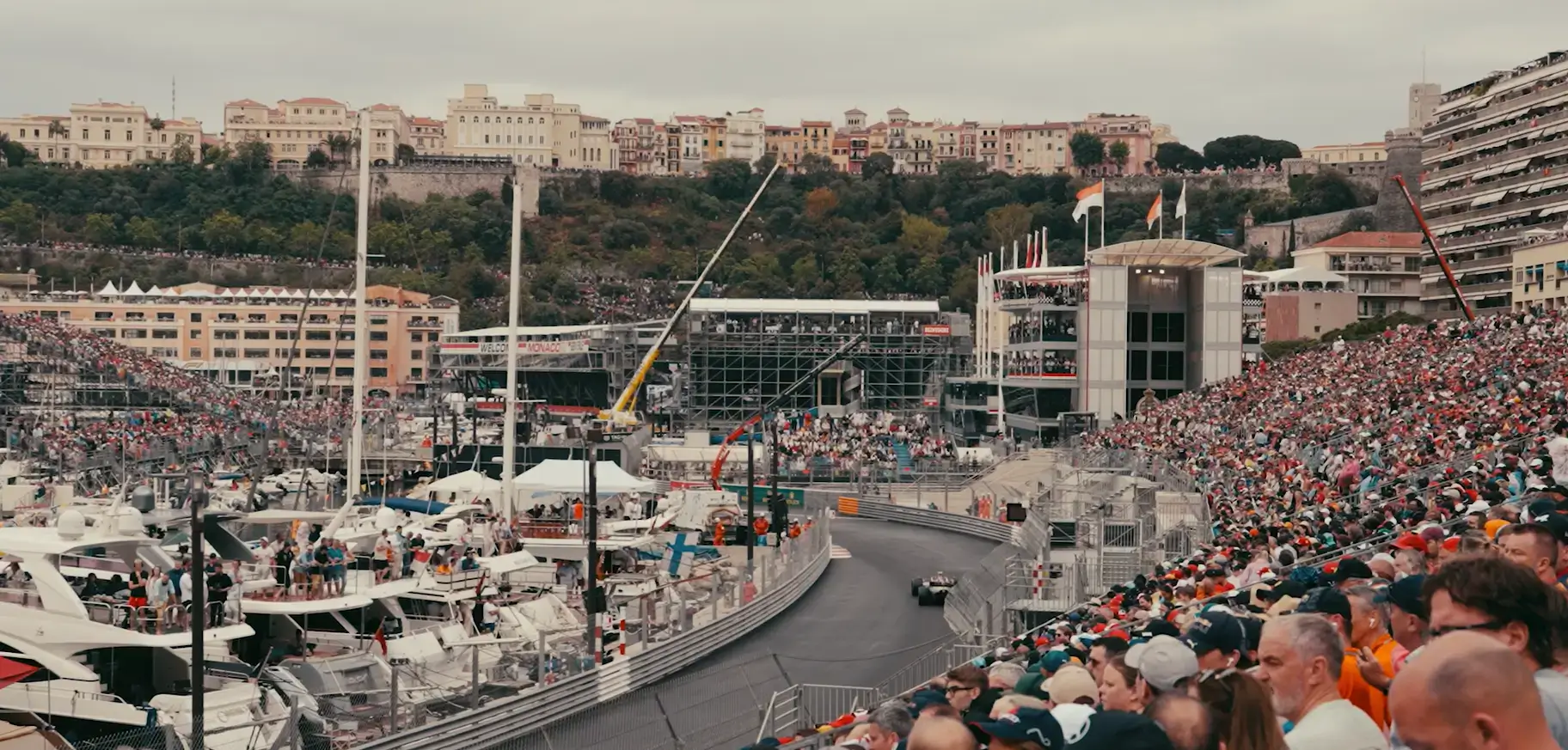 Monaco grand prix race track in action with a packed grand stand